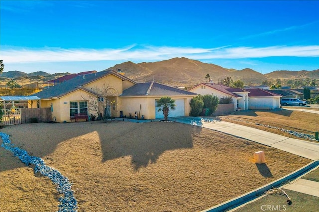 ranch-style home with a mountain view and a garage