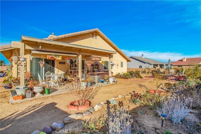 back of property with a patio