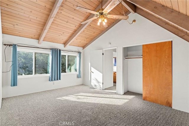 unfurnished bedroom with wood ceiling, a closet, beam ceiling, and carpet floors