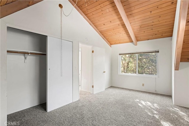 unfurnished bedroom featuring carpet floors, high vaulted ceiling, a closet, wooden ceiling, and beamed ceiling