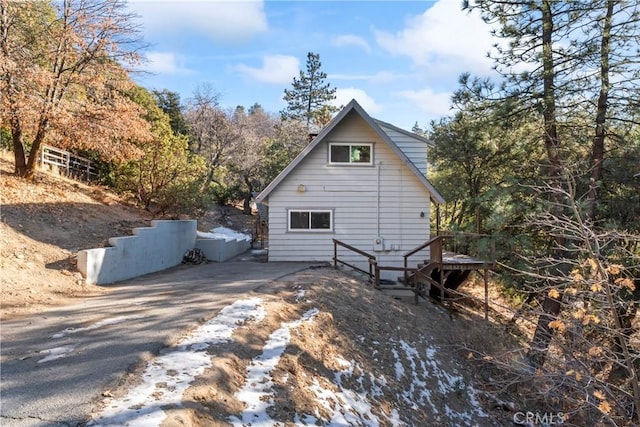 view of side of home with aphalt driveway