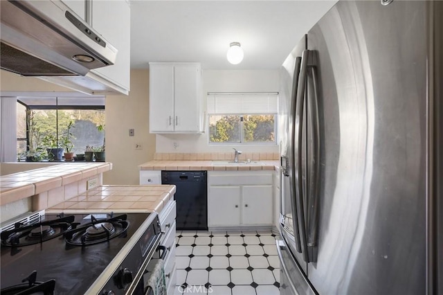 kitchen featuring black appliances, sink, tile counters, and white cabinetry