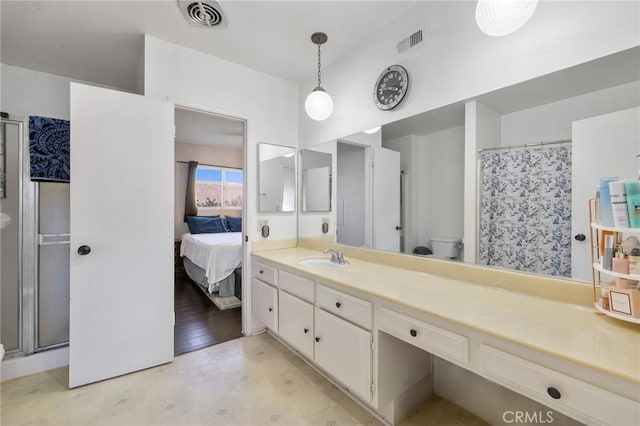 bathroom with toilet, vanity, and walk in shower