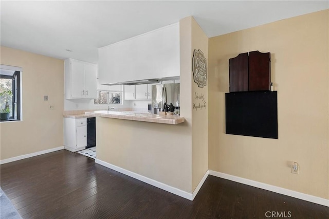 kitchen featuring tile countertops, kitchen peninsula, stainless steel refrigerator with ice dispenser, dark hardwood / wood-style floors, and white cabinets