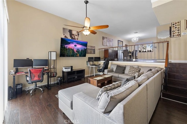 living room with dark wood-type flooring and ceiling fan with notable chandelier