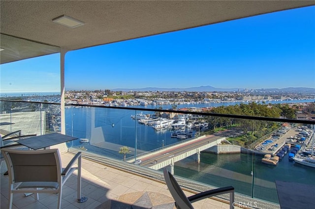 balcony featuring a water and mountain view