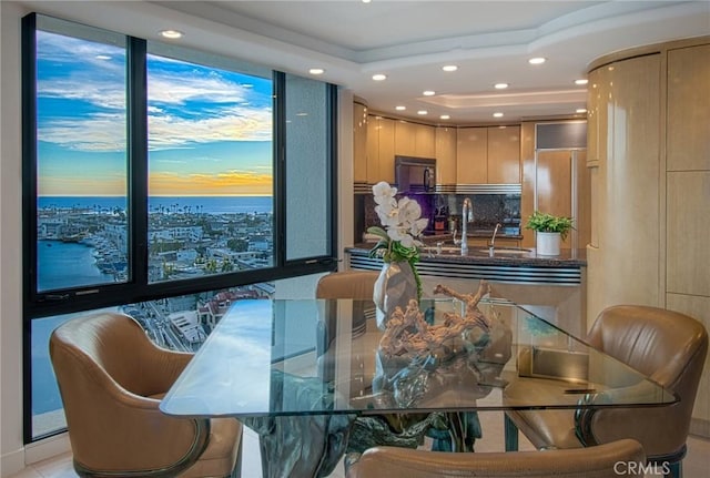 dining room with a water view and sink