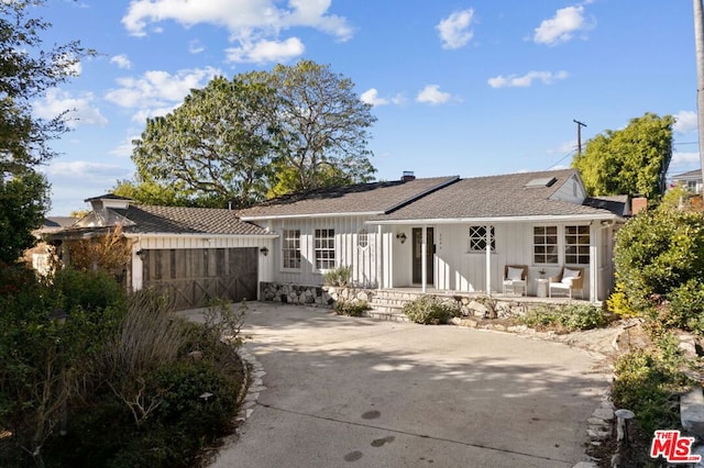 rear view of house featuring a porch