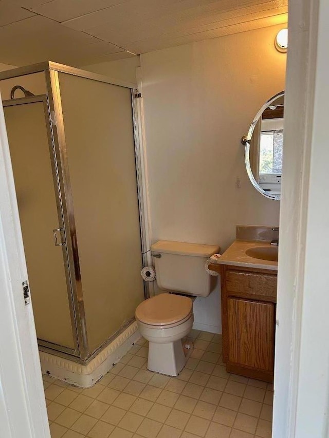 bathroom featuring an enclosed shower, vanity, and toilet