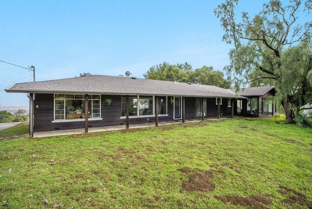 view of front facade with a front yard and a patio area