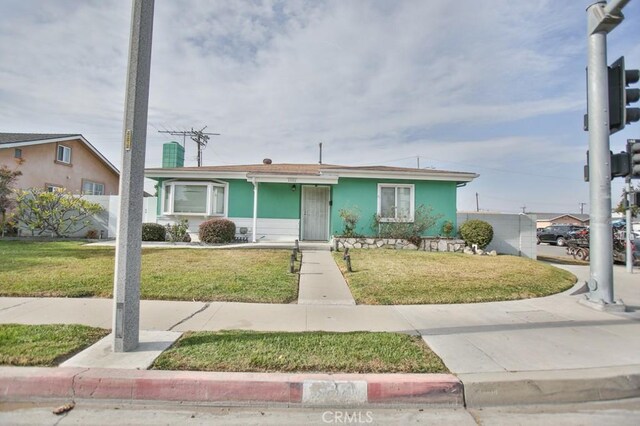 ranch-style home with a front lawn