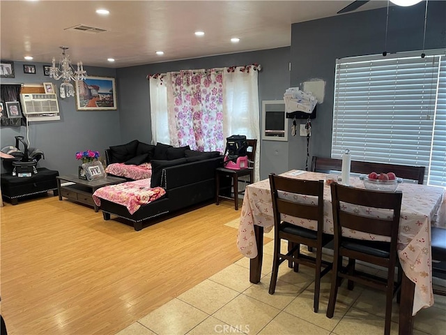 dining room featuring light tile patterned floors and a wall mounted AC