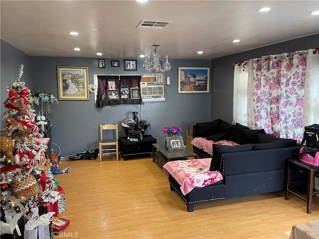 living room featuring a chandelier and light hardwood / wood-style flooring