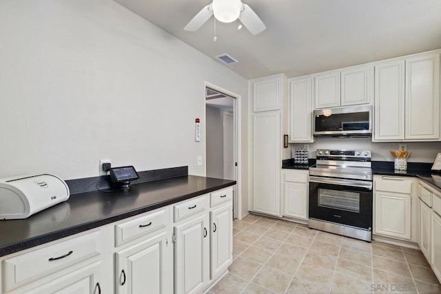 kitchen featuring ceiling fan, appliances with stainless steel finishes, and white cabinetry