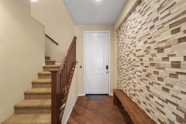 stairs featuring hardwood / wood-style floors