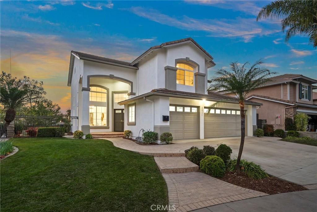 view of front of house with a garage and a yard