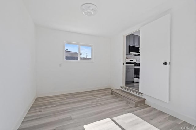 unfurnished room featuring light hardwood / wood-style floors