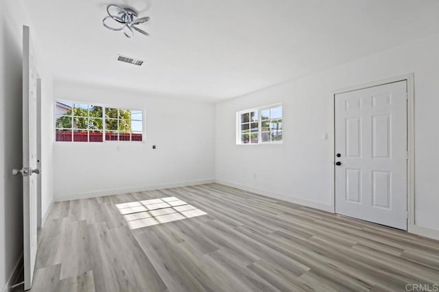 unfurnished room with light wood-type flooring