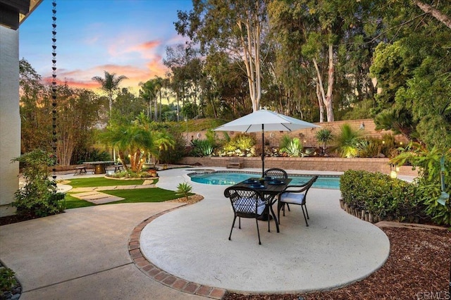 pool at dusk with a patio