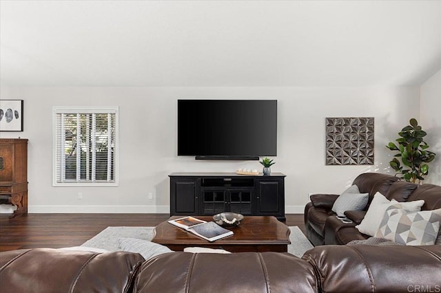 living room featuring dark wood-style flooring and baseboards