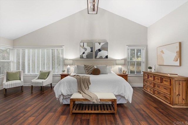 bedroom featuring high vaulted ceiling, multiple windows, and wood finished floors