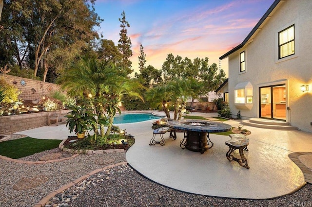 view of swimming pool with a fenced in pool, an outdoor fire pit, a patio, and fence