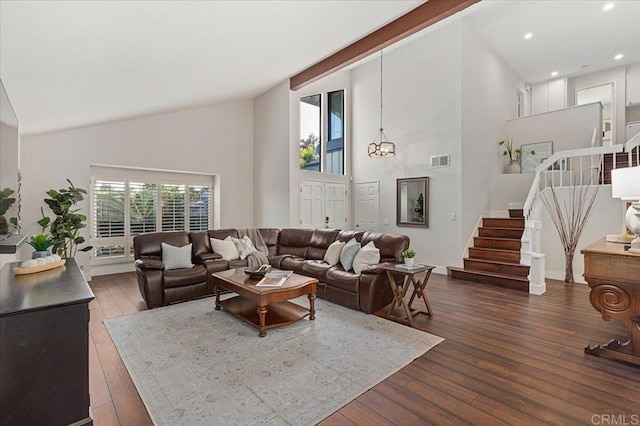 living area with high vaulted ceiling, stairway, wood-type flooring, and visible vents