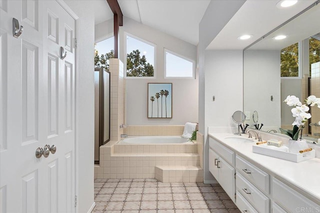 full bathroom featuring recessed lighting, vanity, a bath, and a healthy amount of sunlight