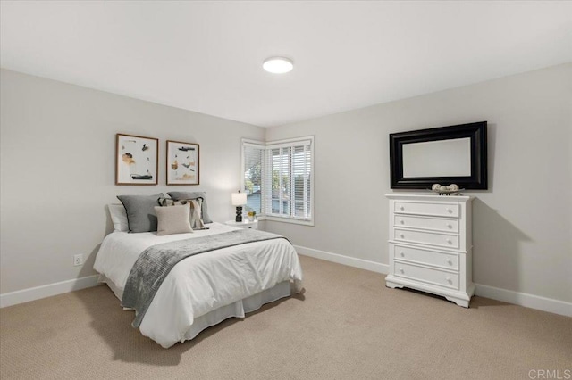 carpeted bedroom featuring baseboards