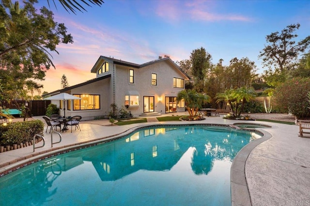 view of swimming pool featuring a patio area, fence, and a fenced in pool