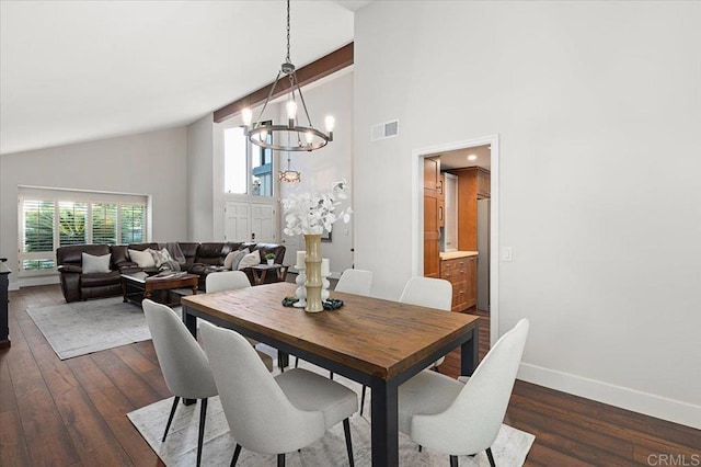 dining room featuring baseboards, visible vents, dark wood-type flooring, an inviting chandelier, and high vaulted ceiling