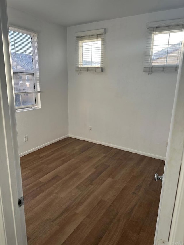 spare room featuring dark hardwood / wood-style flooring