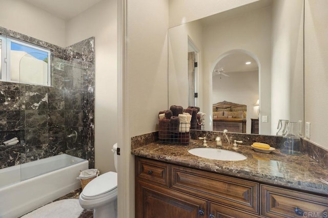 bathroom featuring toilet, shower / tub combination, and vanity