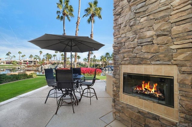 view of patio with an outdoor stone fireplace