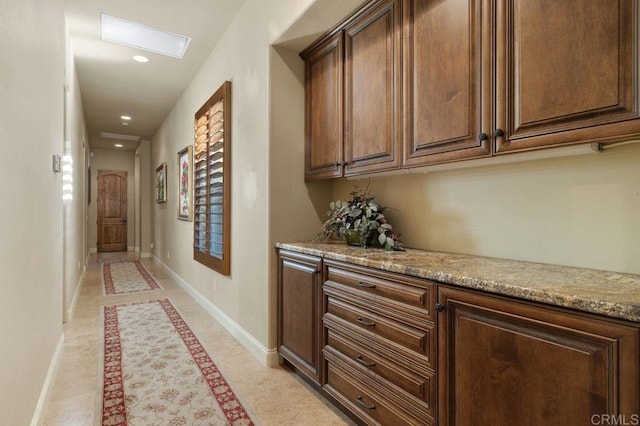 hallway with recessed lighting and baseboards