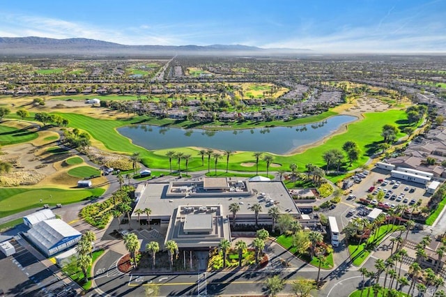 birds eye view of property with golf course view and a water and mountain view