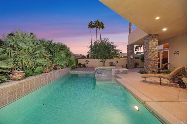 pool at dusk with a patio, a fenced backyard, and a fenced in pool