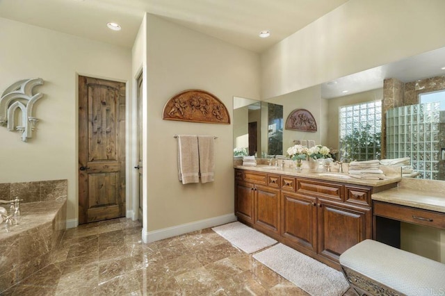 bathroom with recessed lighting, baseboards, a bath, and vanity