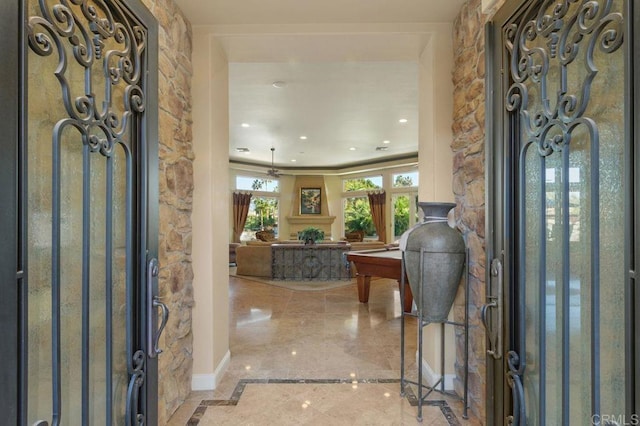 entryway with marble finish floor, a fireplace, and recessed lighting