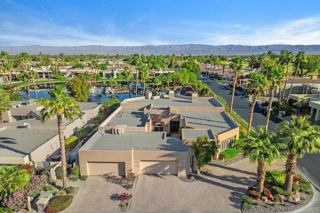 drone / aerial view featuring a residential view and a mountain view