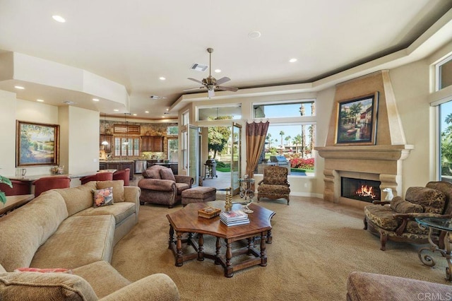 living room with recessed lighting, a large fireplace, light carpet, a ceiling fan, and visible vents