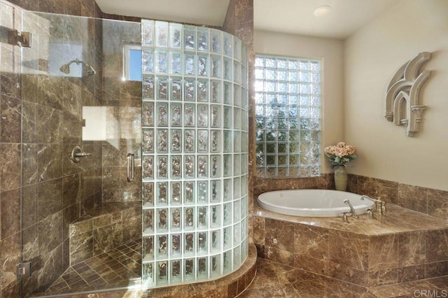 full bath featuring a stall shower and a garden tub