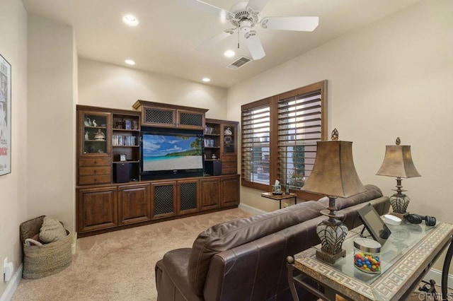 living room featuring light carpet, baseboards, visible vents, a ceiling fan, and recessed lighting