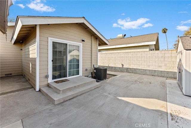 view of patio / terrace featuring central air condition unit and a storage shed