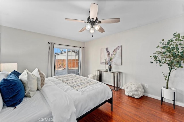 bedroom with ceiling fan, dark hardwood / wood-style floors, and access to outside