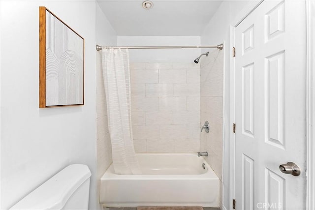 bathroom with toilet and shower / bath combo