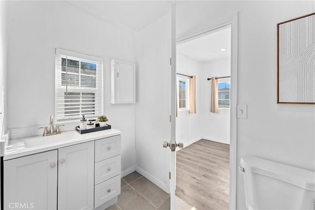 bathroom featuring tile patterned floors, vanity, and toilet