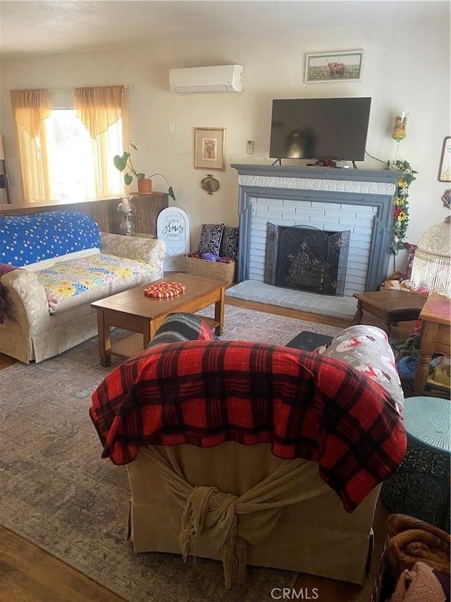 living room with a wall unit AC, a fireplace, and wood-type flooring