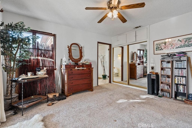 bedroom with light carpet, a closet, a textured ceiling, and ceiling fan