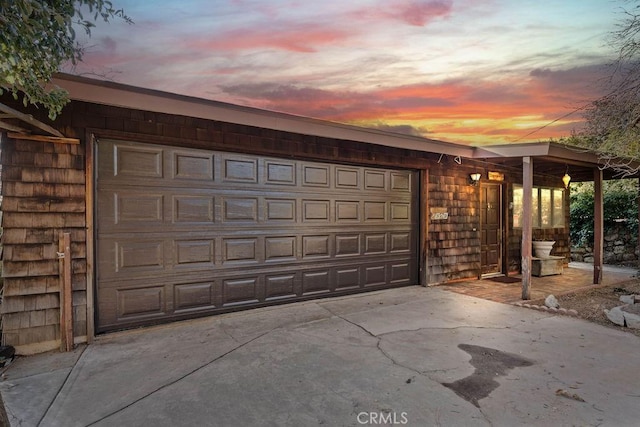 view of garage at dusk